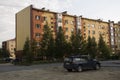 Modern five-storeyed house with flats. It was colored in red, orange and white colors Royalty Free Stock Photo