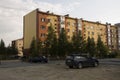 Modern five-storeyed house with flats. It was colored in red, orange and white colors