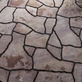 Abstract background of brown sandstone slabs with cracked lines on garden walkway