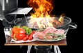 Modern flaming barbecue grill near uncooked food on black background Royalty Free Stock Photo