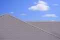 modern flat concrete gray tile roof against white cloud in blue sky background Royalty Free Stock Photo