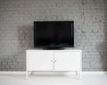 Modern flat lcd television set on white cabinet. Royalty Free Stock Photo