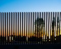 Modern floating metal fence silhuette on sunset.