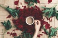 modern floral instagram blogging image. hand holding stylish coffee and beautiful red peonies on rustic wooden background flat la