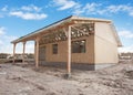 Modern frame energy efficient house under construction with membrane coverings, roof shingles and insulation materials.