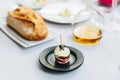 Modern French appetizer: Mini hamburger including white bun, pork, sliced cucumber, tomato and raddish topping with black sesame Royalty Free Stock Photo