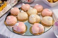 Modern french mousse cake with pink mirror glaze in the shape of a heart on a table.