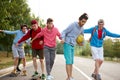 Modern friendly guys in casual clothes skateboarding and showing exciting tricks