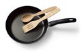 A modern frying pan with a wooden spoon and spatula. Royalty Free Stock Photo