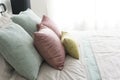 Bedroom with pastel pink and green accents pillows. Royalty Free Stock Photo