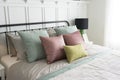 Bedroom with pastel pink and green accents pillows. Royalty Free Stock Photo