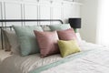 Bedroom with pastel pink and green accents pillows. Royalty Free Stock Photo