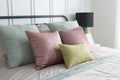 Bedroom with pastel pink and green accents pillows. Royalty Free Stock Photo