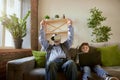 Portrait of happy senior man and little boy, grandfather and grandson using VR glasses sitting on sofa at home and Royalty Free Stock Photo