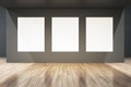 Modern gallery interior with concrete walls, empty white mock up posters and wooden flooring. Royalty Free Stock Photo