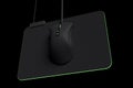 Modern gaming mouse on professional pad on black background with clipping path