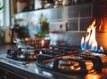 Modern gas stove with blue flames in a well-equipped kitchen, pots and pans in the background. Royalty Free Stock Photo