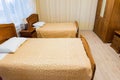 Interior of modern economy hotel room with twin beds in beige colour Royalty Free Stock Photo