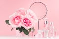 Modern gentle girlish bathroom decor - cosmetics for bath, spa, bouquet of roses, round mirror, bath accessories on white wood. Royalty Free Stock Photo