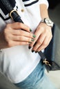 Modern girl with green nail Polish and a trendy bag in stylish jeans. The style life, trending Royalty Free Stock Photo