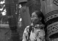 Modern girl Yakut pressed against the sacred pillar Serge in the storage of old pillars in the Park.