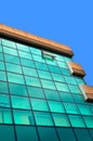 Modern glass building in the city center, business center with blue sky Royalty Free Stock Photo