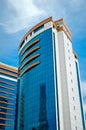 Modern glass building in the city center, business center with blue sky Royalty Free Stock Photo