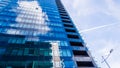 Modern glass building exterior summer day clouds sky Royalty Free Stock Photo