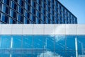 Modern glass building facade against the blue clear sky Royalty Free Stock Photo