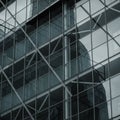 Modern glass building facade featuring a grid of reflective panels. Visible structural Royalty Free Stock Photo