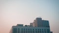 Modern glass building with reflected evening city and sunset sky in it Royalty Free Stock Photo