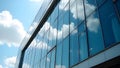 Modern Glass Building Reflecting Blue Sky and Clouds on Sleek Architectural Facade Royalty Free Stock Photo