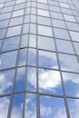 Modern glass building with reflections of blue sky and clouds Royalty Free Stock Photo