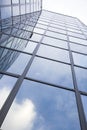 Modern glass building with reflections of blue sky and clouds Royalty Free Stock Photo