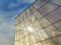 Modern glass building under the blue sky.Sun rays light effects on urban buildings. Abstract image of looking up at modern Royalty Free Stock Photo