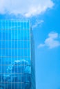 Office building with blue sky and clouds in window reflection Royalty Free Stock Photo