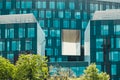 Modern glass commercial exterior of office building architecture. Window covered abstract building with green trees in Royalty Free Stock Photo