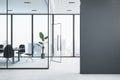 Modern glass conference room interior with empty mock up place on wall, furniture and panoramic window with city view and daylight Royalty Free Stock Photo