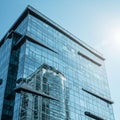 Modern glass-covered building with a reflective facade, featuring a grid-like pattern. Royalty Free Stock Photo