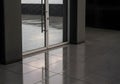 Modern Glass Double Doors with Raindrops and Wet Stone Floor Royalty Free Stock Photo