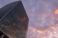 Modern glass high rise business building with reflected sunset in it. Wallpaper. Evening red clouds. Copy space. Great city view Royalty Free Stock Photo