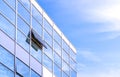Modern glass office building against blue sky background in low angle and perspective side view Royalty Free Stock Photo