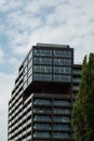 Modern glass office building exterior with glass facade on clear sky background. Transparent glass wall of office Royalty Free Stock Photo