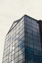 Modern glass office building exterior with glass facade on clear sky background. Transparent glass wall of office Royalty Free Stock Photo