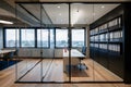 Modern glass partition with workstations flooded with natural and recessed lighting for a serene workspace Royalty Free Stock Photo