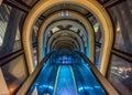 Modern glass tunnel escalator between two buildings Royalty Free Stock Photo