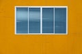Modern glass window on the yellow wall Royalty Free Stock Photo