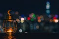 Modern golden lantern that have moon symbol on top with colorful city bokeh lights