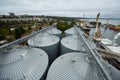 Modern grain terminal. Metal tanks of elevator. Grain-drying complex construction. Commercial grain or seed silos at Royalty Free Stock Photo