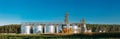 Modern Granary, Grain-drying Complex, Commercial Grain Or Seed Silos In Sunny Summer Rural Landscape. Corn Dryer Silos Royalty Free Stock Photo